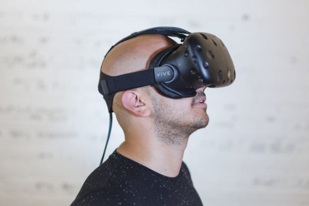 Man wearing an HTC-Vive Virtual Reality (VR) headset